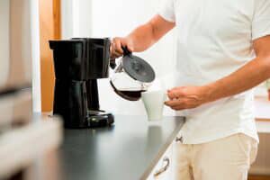 Person pouring a cup of coffee